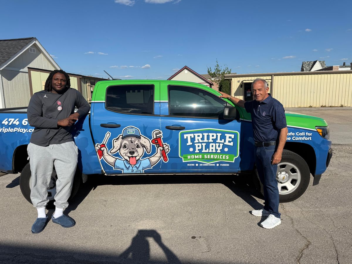 David Robinson and Ron Gregory in front of a Triple Play Home Services branded truck