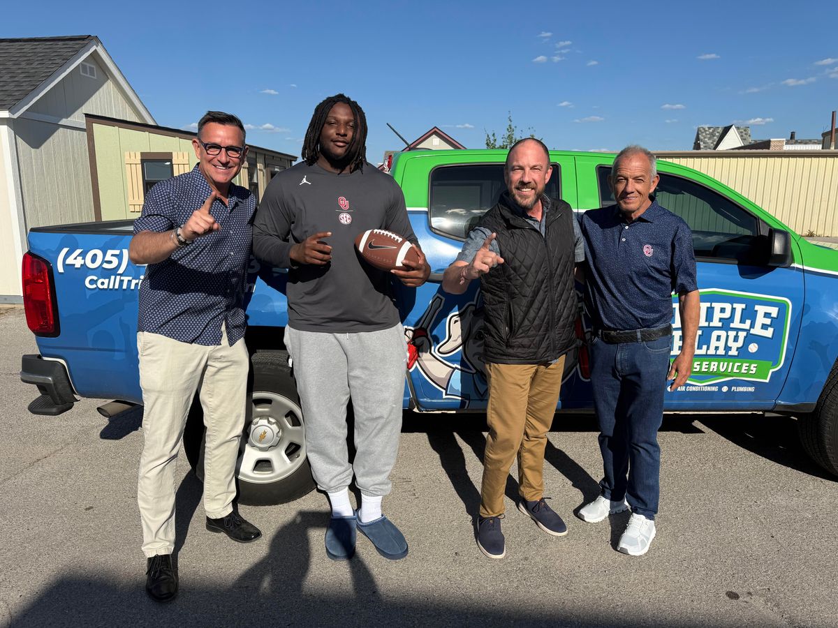 RECON-nect co-founders Chase Rutledge and Bradley Dean in front of a Triple Play Home Services branded truck